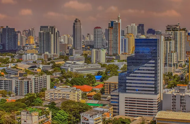 The Bangkok skyline of high-rises and glass towers under a dusky sky
