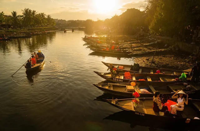 Wooden boats on the river at sunset in Hoi An, Vietnam