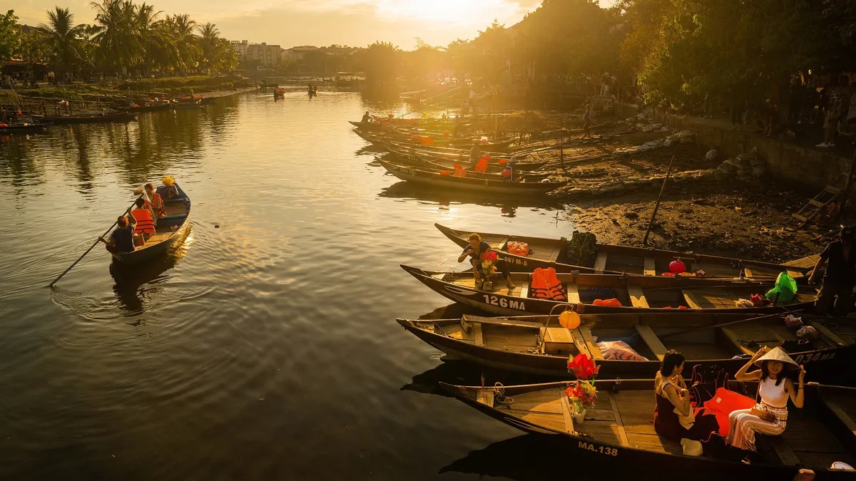 Wooden boats on the river at sunset in Hoi An, Vietnam
